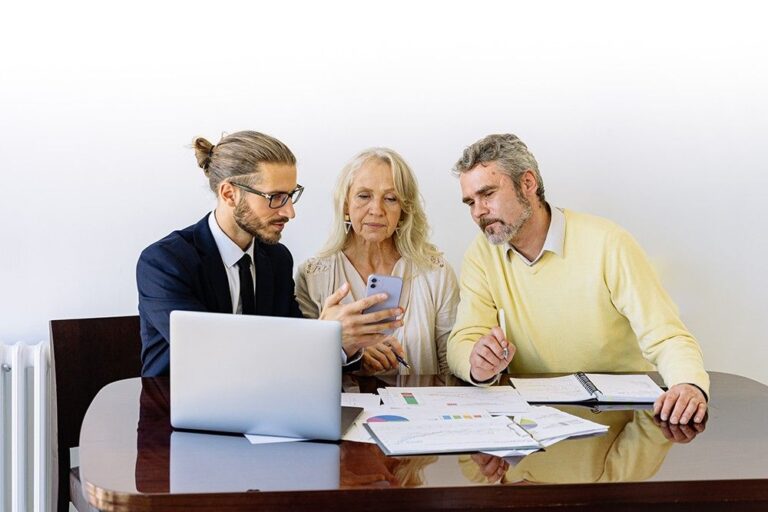 Three people discussing over documents