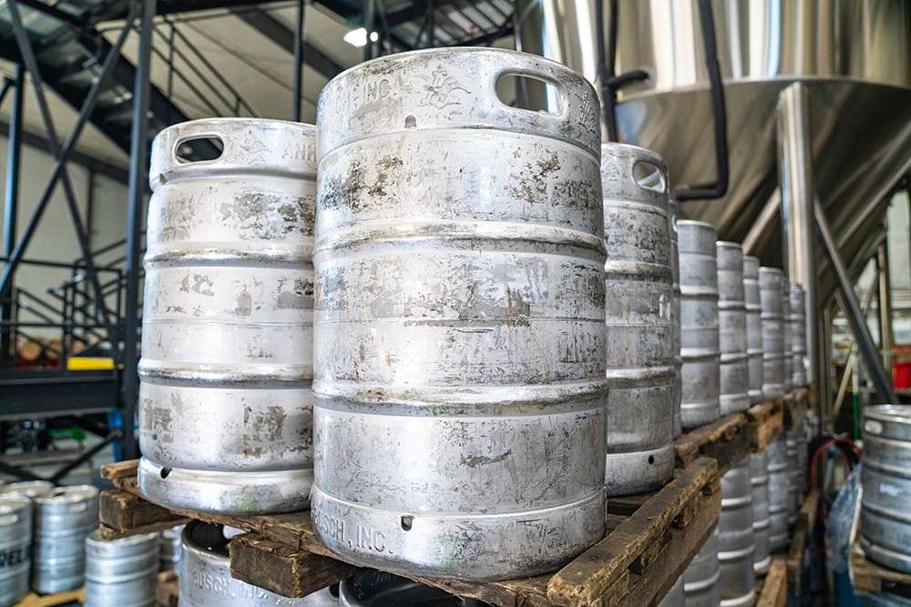 Stacked metal kegs in brewery